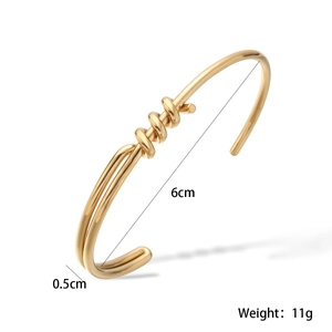 Detail showing 6cm inner diameter and 0.5cm width of the 18K gold knot cuff bracelet