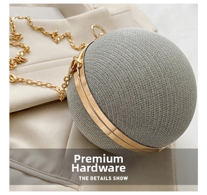 Macro shot of silver sphere evening bag with gold metal frame and glitter fabric texture