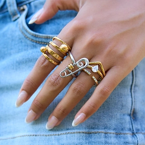 Stackable zircon rings set with safety pin design in gold and silver finish on hand