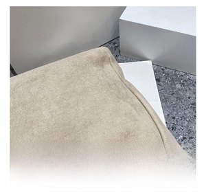 Detailed close-up of beige knitted fabric texture on large tote bag showing soft weaving