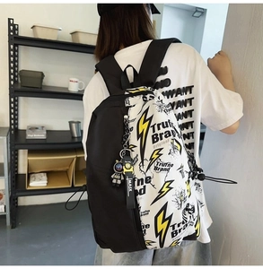 Street style backpack with yellow lightning print shown as a back-view lifestyle shot
