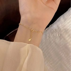 Detail view of gold S925 sterling silver minimalist bracelet with adjustable chain extender