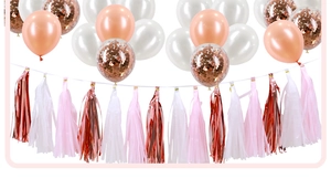 Close-up of rose gold balloons and tassels for bridal shower and wedding party decor