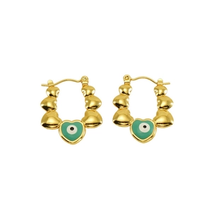 Detail of vintage gold heart earrings with green evil eye enamel inlay on white background