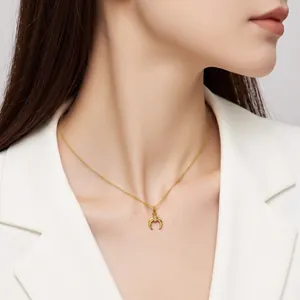 Elegant gold crescent moon necklace with zircon stone worn by a model on neck