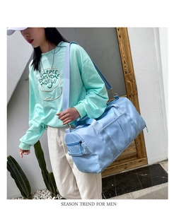 Light blue high-capacity waterproof travel bag featuring adjustable shoulder straps