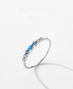 Detail of S925 sterling silver ring with blue zircon and small white diamonds