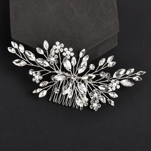 Silver bridal hair comb with crystal leaves and white pearls on black background
