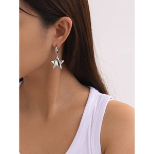 Minimalist 18k stainless steel star hoop earrings shown worn on model for modern style