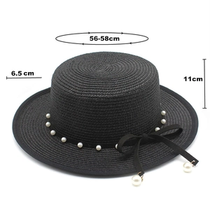 Detail of flat top straw hat with dimensions 56-58cm, pearl trim and black bow