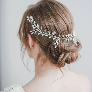 Silver marquise crystal bridal hair vine accessory for wedding updos shown on a model