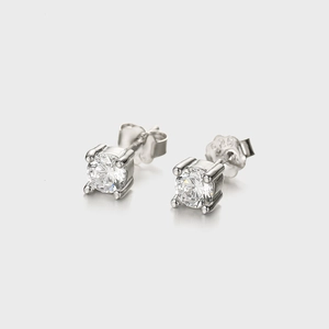 Macro detail of S925 sterling silver four-claw stud earrings with clear zircon stones