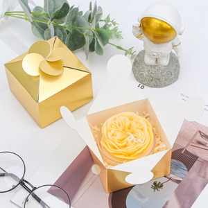 Detail of a golden petal-top gift box for candles or soap with decorative props