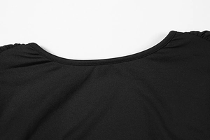 Detail of black crew neck dress featuring pleated shoulder design and smooth fabric texture