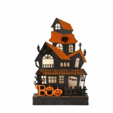 Detail of a light-up wooden Halloween ghost house decoration with glowing orange BOO sign