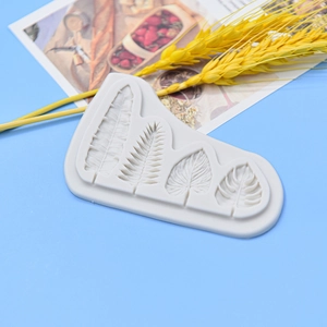 Silicone fondant mold featuring various tropical monstera and fern leaf patterns for cakes