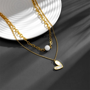 Close-up of double-layer stainless steel gold necklace with heart shell pendant