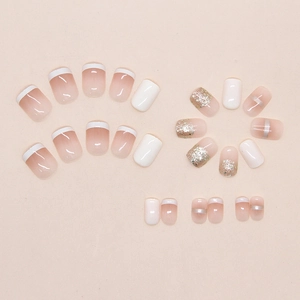 Detailed set of French ombre press-on nails with champagne glitter and white tips