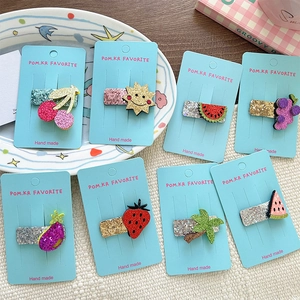 Cute set of 8 glitter strawberry and cherry hair clips for girls in a stylish scene