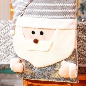 Detail of Santa Claus chair cover with gray knit fabric, plush beard and silver sequins