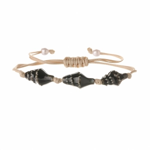 Detail of bohemian woven bracelet with ceramic conch beads and white pearls