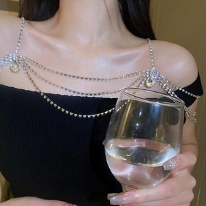 Detail of layered rhinestone shoulder chain with teardrop pendant on model shoulder