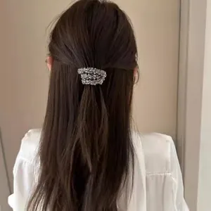 Sparkling crystal bead hair tie shown on a high ponytail for an elegant hairstyle