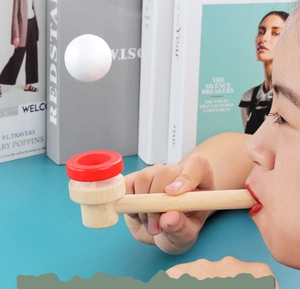 Close-up of a child using the wooden floating ball toy for sensory training
