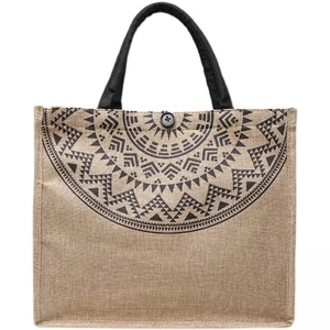Ethnic jute tote bag featuring a black geometric pattern and durable handles