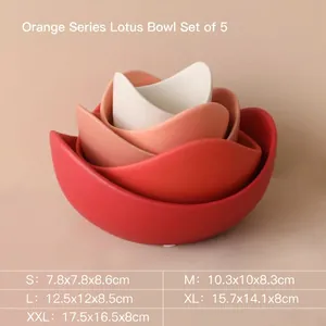 Set of 5 nesting lotus-shaped ceramic bowls in a warm orange gradient color palette