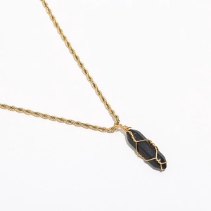 Detail of bohemian twisted rope chain with black hexagonal crystal pendant and gold wire wrap