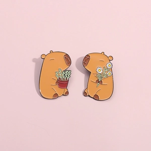 Cute capybara enamel pin set with flower and potted plant on a soft pink background