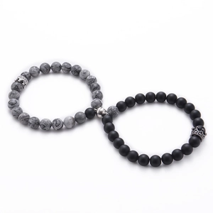 Close-up of 8mm white turquoise and black lava stone crown bracelets with magnetic clasp
