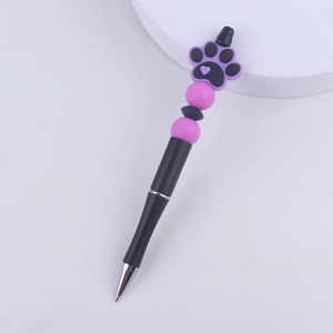 Detailed macro view of DIY beadable pen featuring a purple cat paw silicone topper