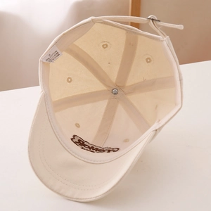 Detail view of cotton baseball cap interior featuring reinforced seams and adjustable buckle