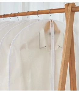 Close-up of translucent hanging garment cover with durable zipper for closet storage