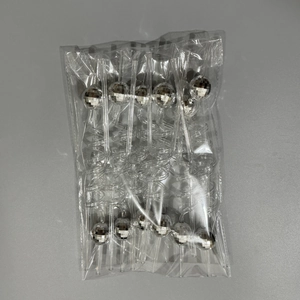 Macro detail of disco ball party straws with silver mirror mosaic spheres in bulk packaging