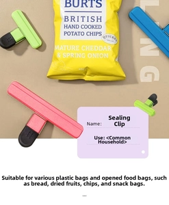 Macro shot of colorful wide plastic sealing clips on opened snack bags for moisture-proof storage