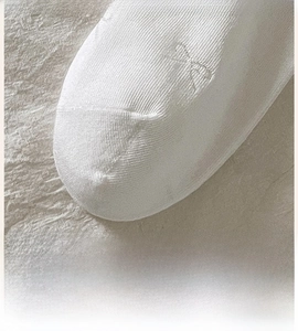 Close-up of seamless white knit sock toe with flat comfortable stitch details