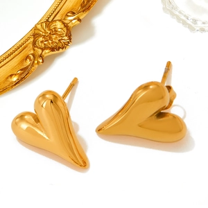 Polished gold heart stud earrings in stainless steel on a minimalist aesthetic background