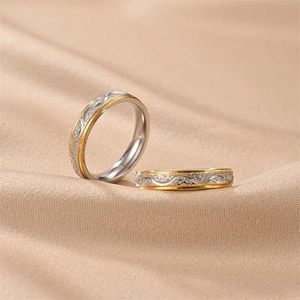 Macro view showing intricate frosted wave patterns on titanium steel couple rings