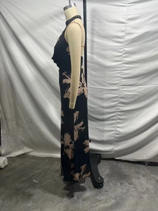 Side view detail of a black mesh maxi dress with beige floral print and halter neckline