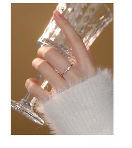Detail of s925 silver ring featuring a small heart-shaped zircon on a minimalist band