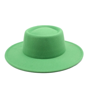 Detailed texture of bright green wool felt fedora with a wide brim and flat top