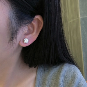 Close-up of S925 sterling silver stud earring with 5A zircon inlay on a model's ear
