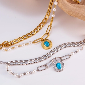 Layered stainless steel bracelet with irregular coin pendants and elegant pearls