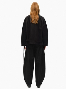 Full back view of women's loose double-breasted trench coat and trousers set in black