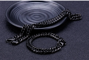 Close-up of black stainless steel Cuban link necklace and bracelet set with lobster clasp