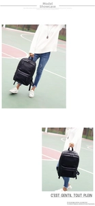 Detailed view of casual black PU leather backpack with sturdy straps and front zipper pocket