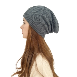 Unisex dark grey slouchy knit beanie featuring a classic cable knit pattern for winter warmth
